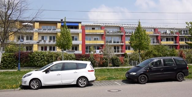 This long residential complex in Freiburg, Germany, is actually two separate buildings. Which one do you think is Passive House? The red one on the right side with the solar panels on top, or the yellow left half? If you can't tell the difference, join the club. (Answer: the Passive House section is the yellow part on the left.)