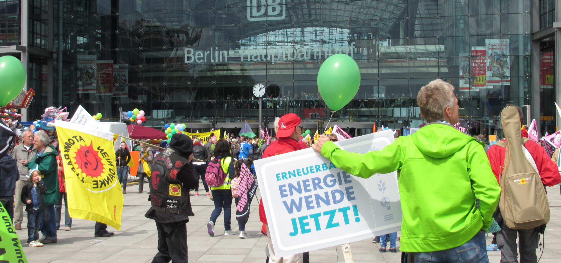 People are preparing for a demonstration for the energytransition in front of the main station in Berlin. 