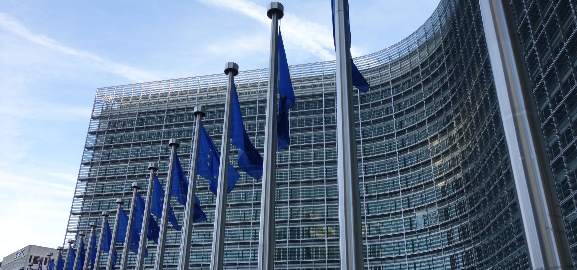 The Berlaymont building in Brussels with flags of the European Union in front of it. 