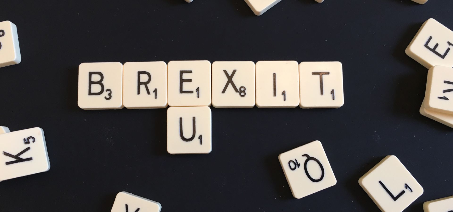 scrabble text with the words brexit and EU spelled out on a black background