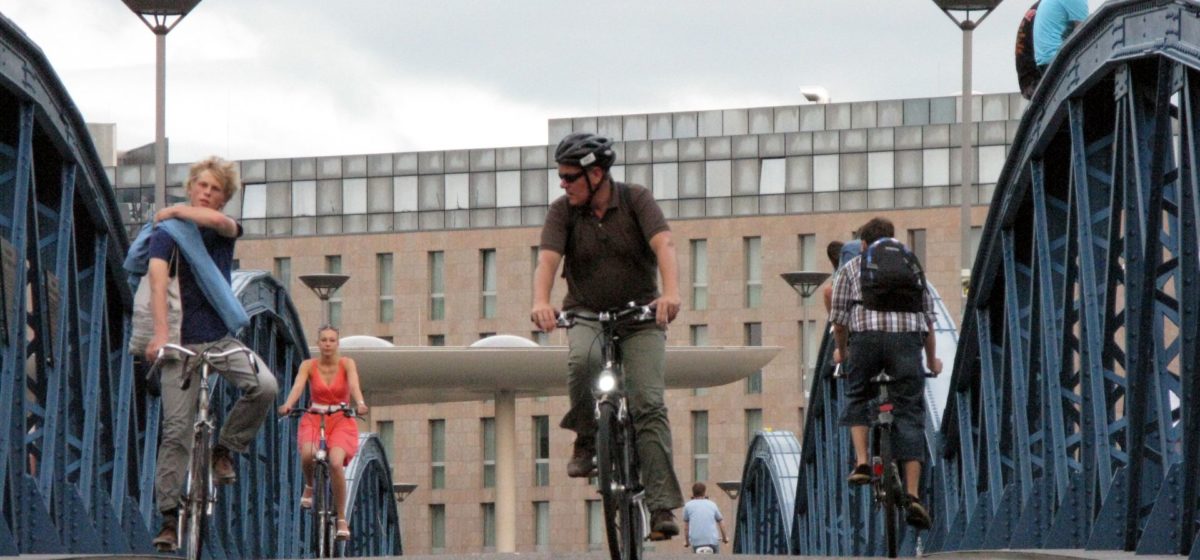 biking across the bridge in Freiburg, Germany