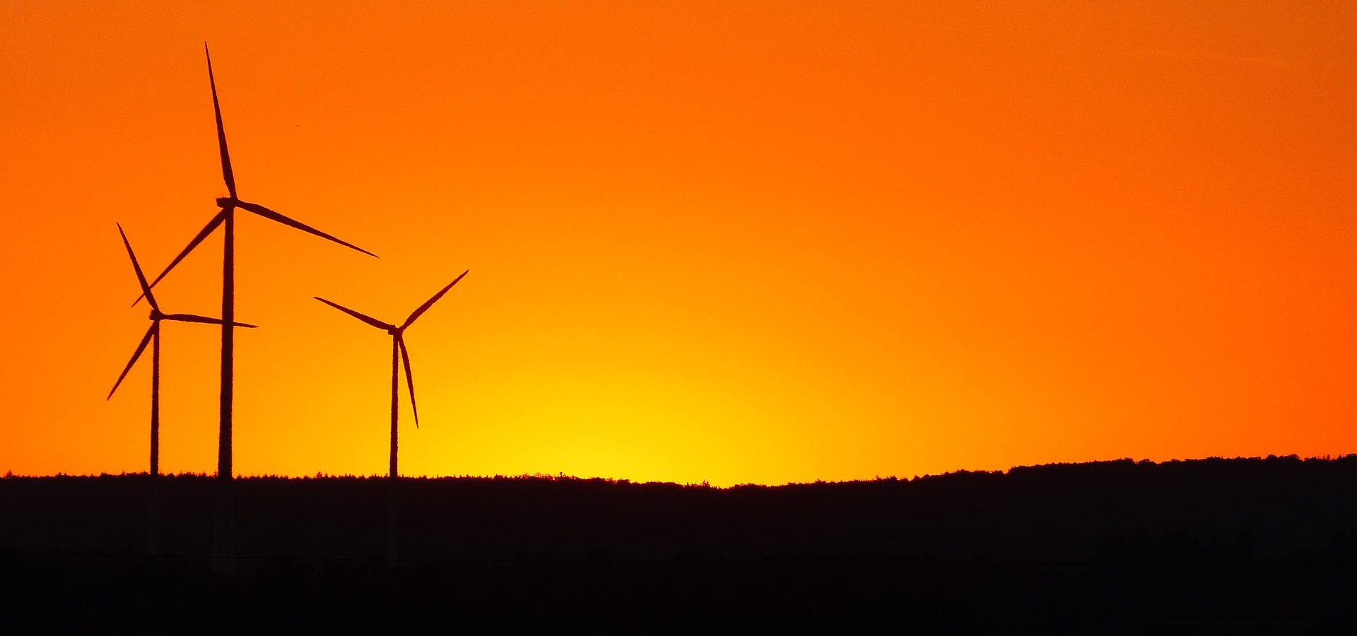 Windmills against a bright sunset