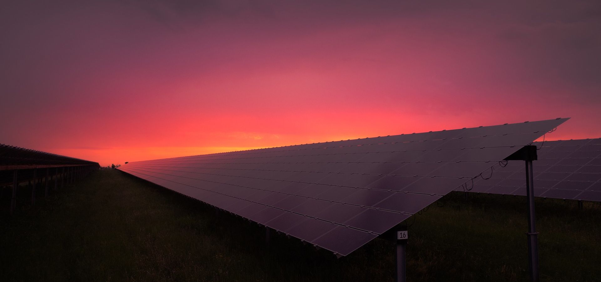 sunrise behind a solar panel