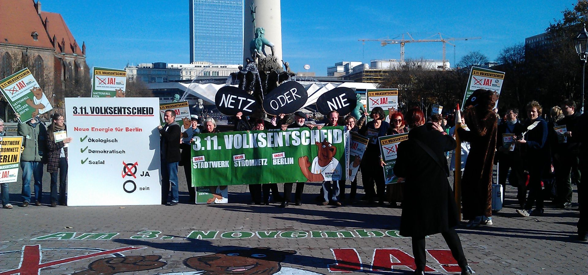 Gathering in front of the TV tower in Berlin, protesters with signs saying yes to new energy for Berlin