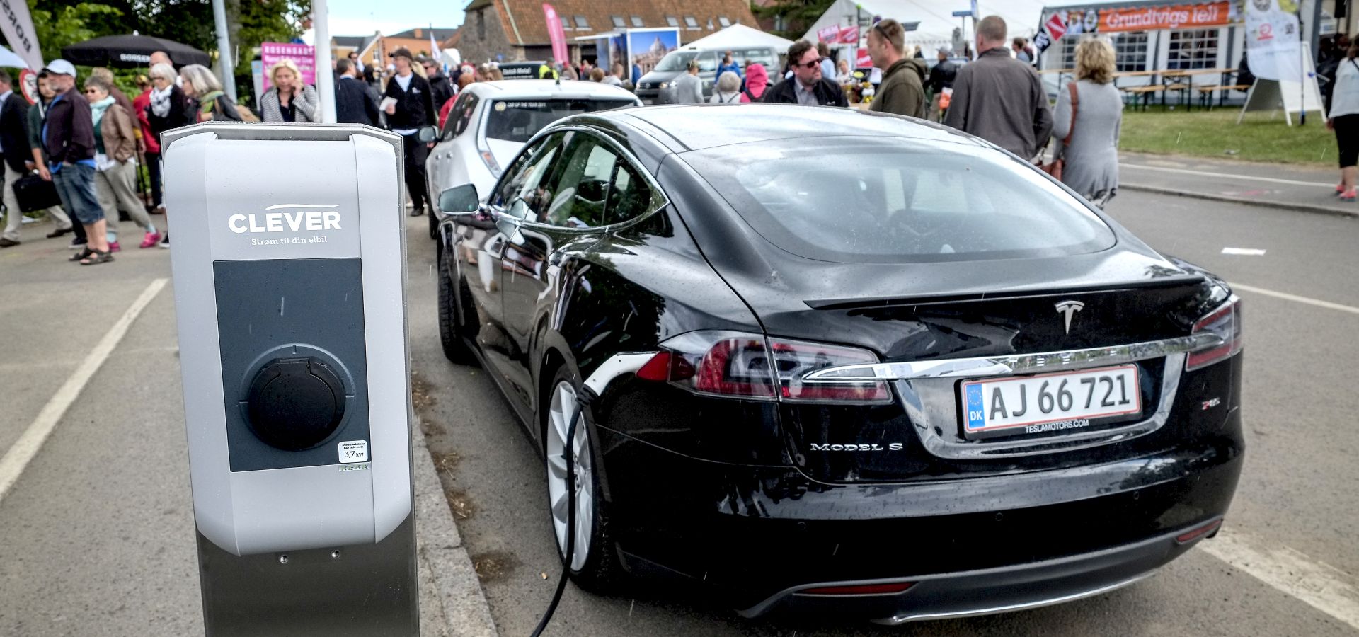 Black model S Tesla charging in a street in Denmark