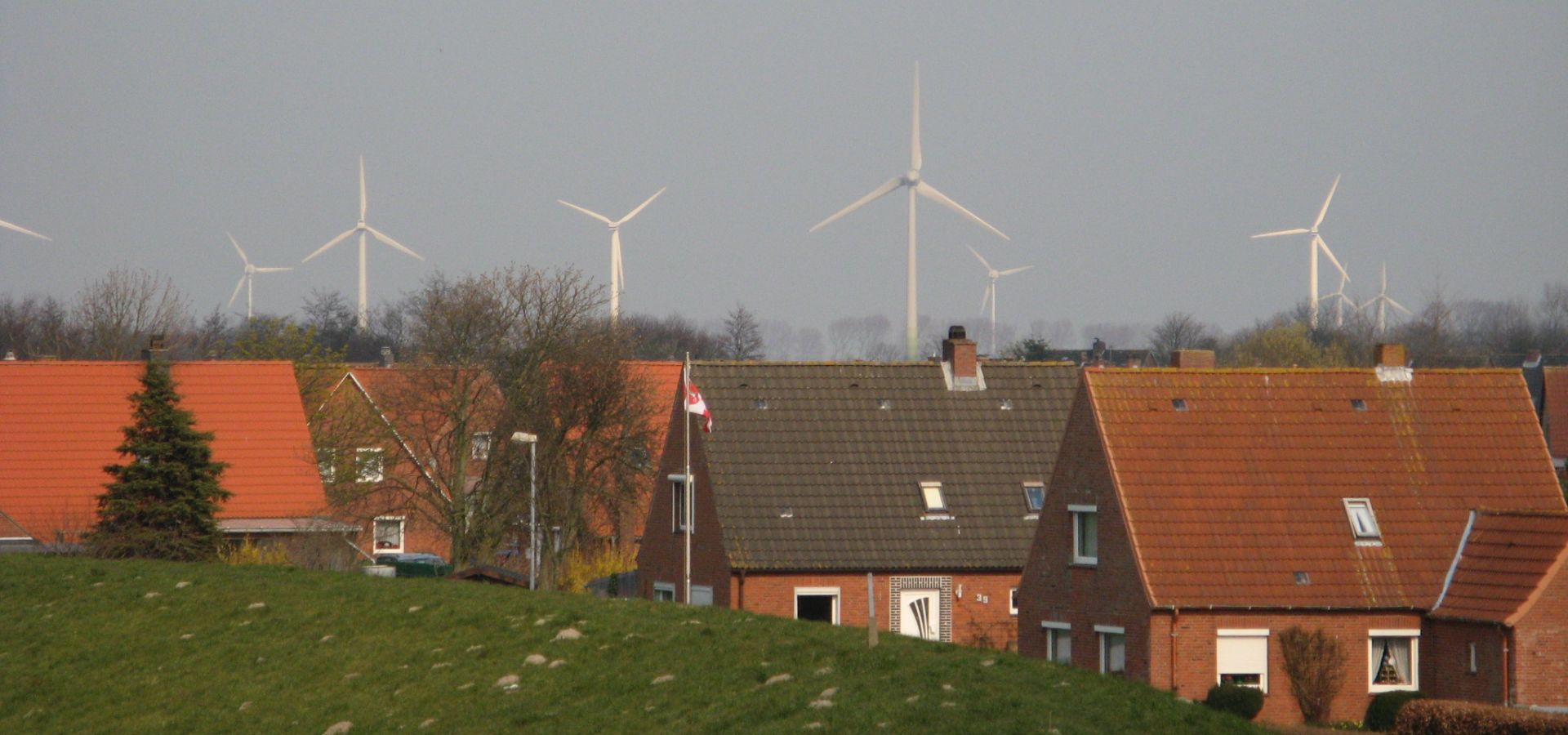 small red brick houses with windmills in the background