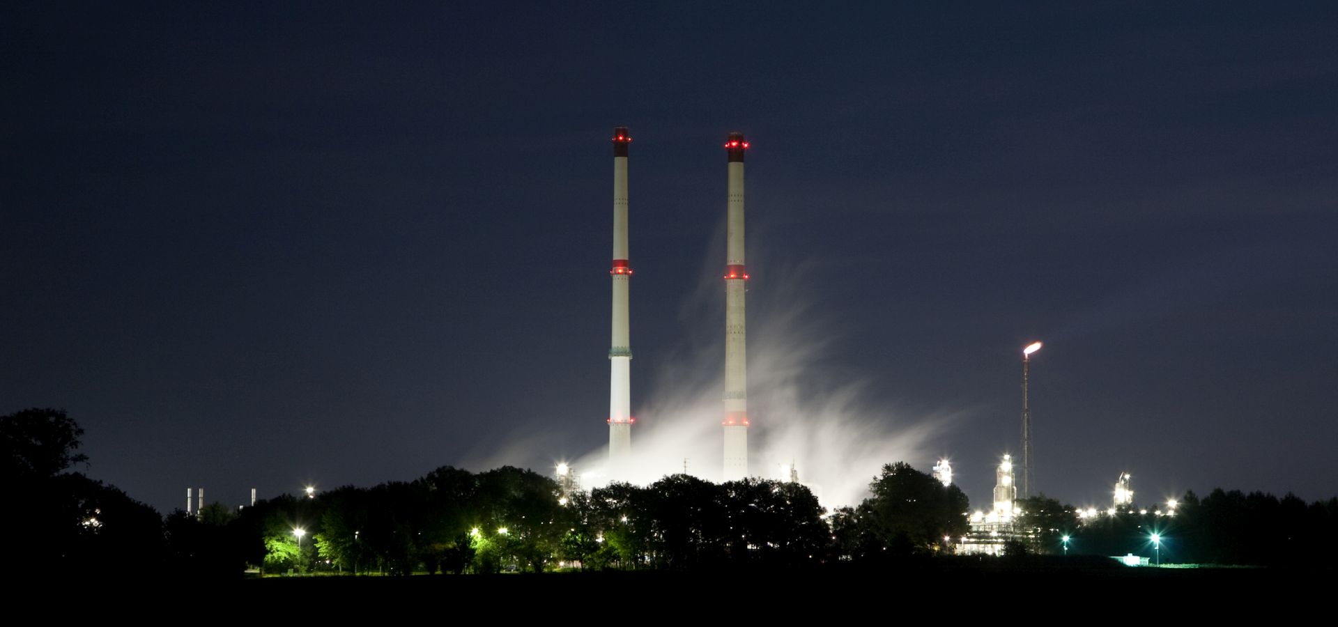 natural gas cleaning plant towers glowing at night