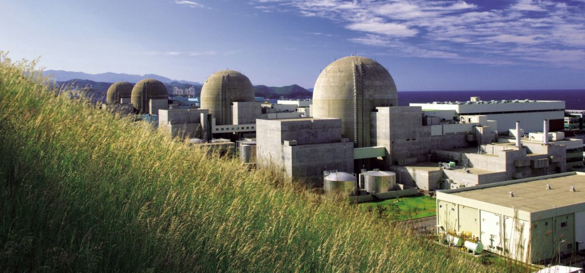 Hanul power plant cooling towers seen from a grassy hill