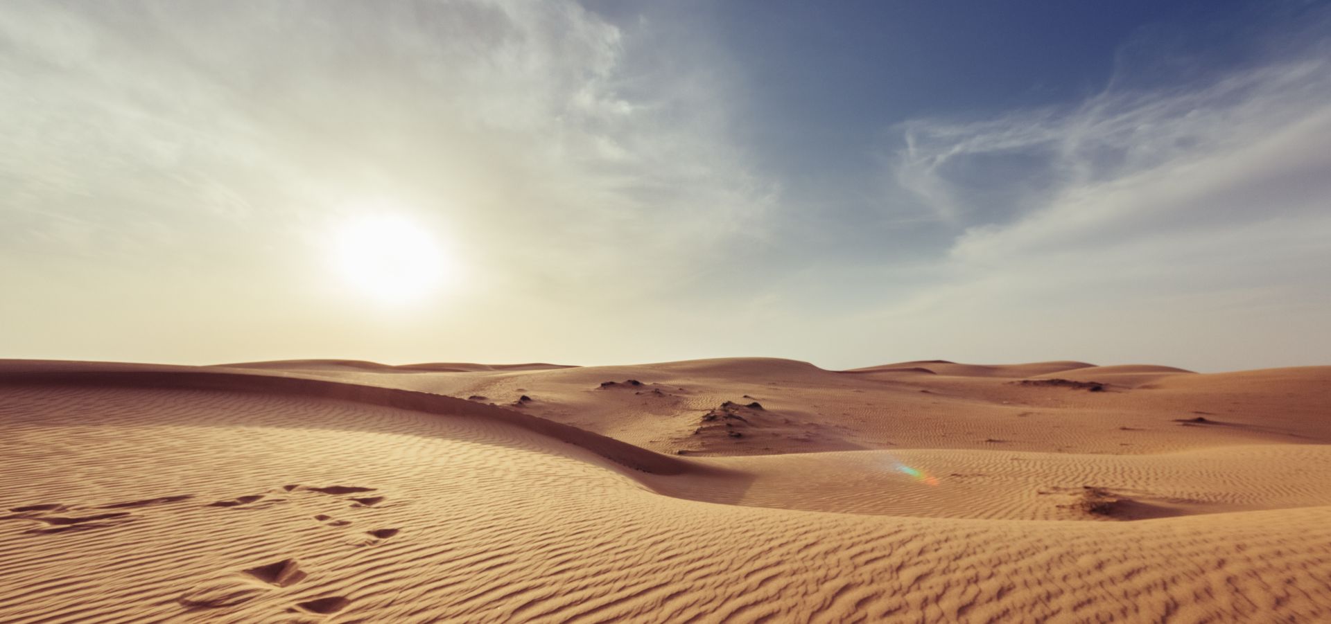 sun shining over the desert in a hazy sky