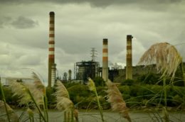 view of the thermal power station Costanera Argentina on a cloudy day with smoke behind