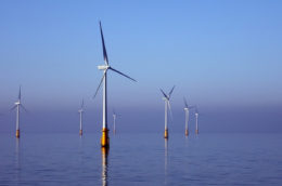 view of offshore wind farm in the irish sea with turbines reflected in the water